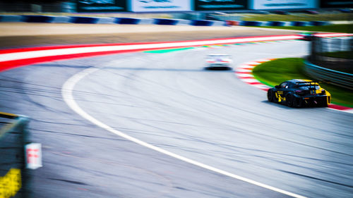 Blurred motion of toy car on road in city