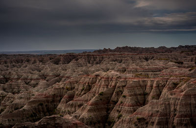 Scenic view of dramatic landscape against cloudy sky