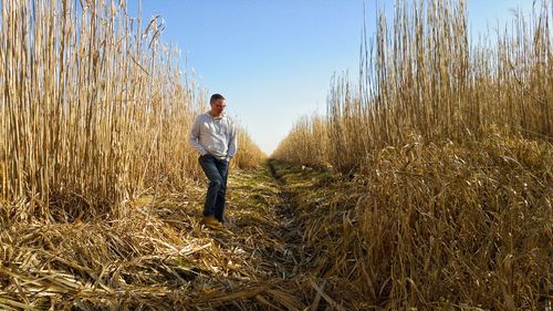 Full length of man standing on field against sky