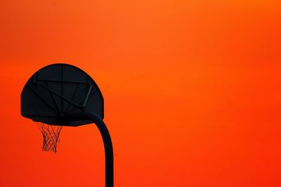 Low angle view of basketball hoop against clear sky during sunset