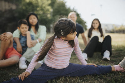 Family relaxing and having fun in park in summer