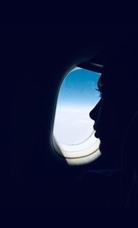 Man looking through airplane window