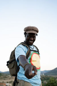 Black african american man with green backpack, travel concept