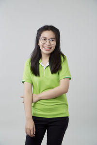 Portrait of a smiling young woman against white background