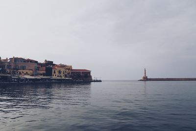 Scenic view of sea and buildings against sky