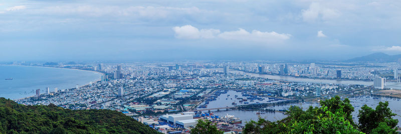 High angle view of buildings against cloudy sky