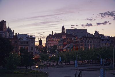 Buildings against sky at sunset