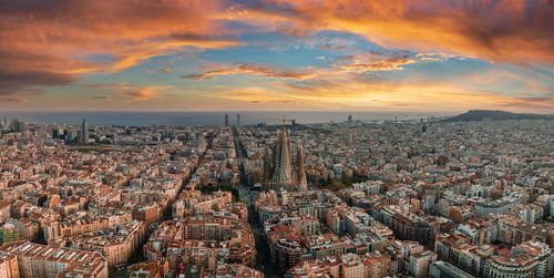 Aerial view of cityscape against sky during sunset