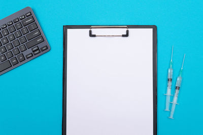 Close-up of laptop on table against blue background