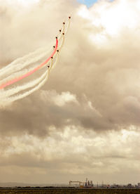 Low angle view of airplane flying against sky