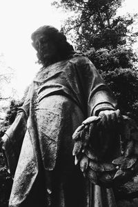 Low angle view of horse statue against trees