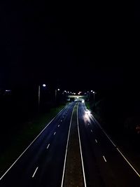 Illuminated road in city at night