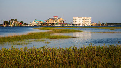 River and buildings against sky