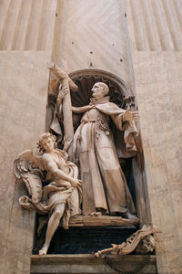 Low angle view of statue against temple