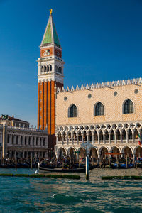 St marks square by grand canal against clear blue sky in city