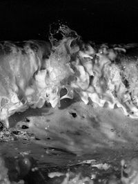 Close-up of water flowing against black background