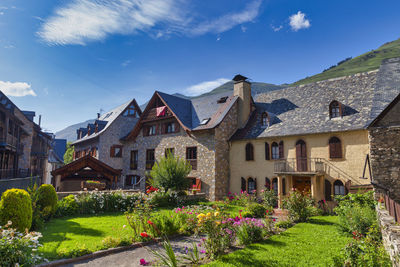 View of houses and buildings against blue sky