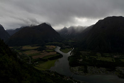 Scenic view of river and mountains against sky