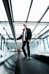 Full length of man standing on escalator