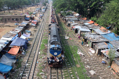 High angle view of railroad tracks amidst trees in city