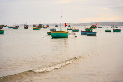 Boats in sea against sky