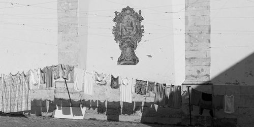 Close-up of clothes hanging on built structure