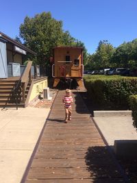 Boy running on track during sunny day