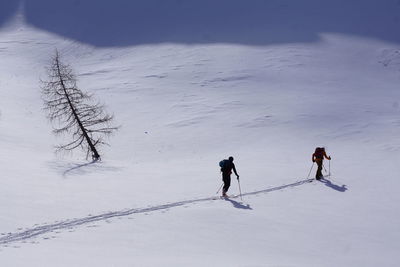 People walking on snow covered field