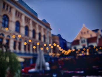 Defocused image of illuminated city buildings at dusk