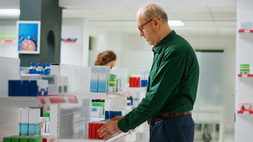 Side view of man working in office