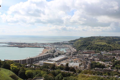 High angle view of townscape by sea against sky