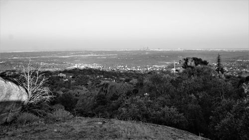 High angle view of trees and cityscape against sky