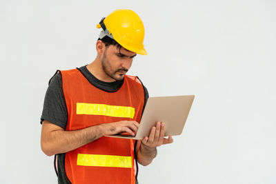 Man working with mobile phone against white background