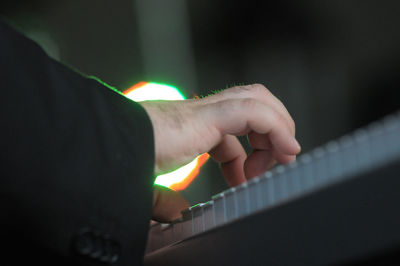 Close-up of hand holding lit candle