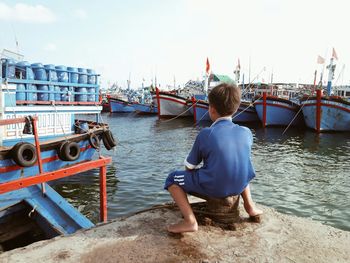 Rear view of woman standing in river