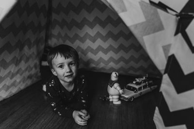 High angle portrait of boy sitting at home