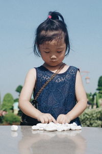 Girl with pebbles on table