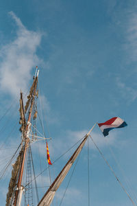 Low angle view of flag against blue sky