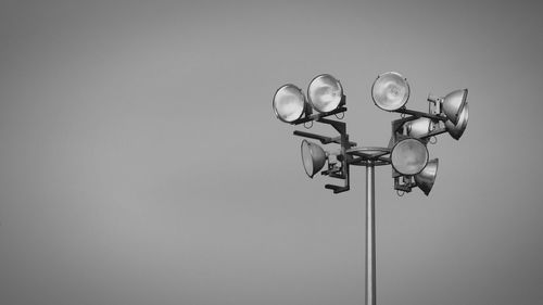 Low angle view of floodlights against sky