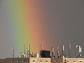 Building roof against sky with rainbow