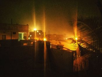 Illuminated building against sky at night