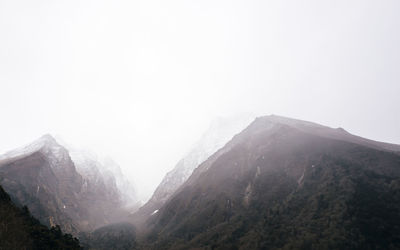 Scenic view of mountains against clear sky during winter