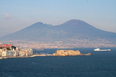 Scenic view of sea by city against sky