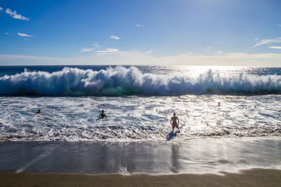 People surfing in sea