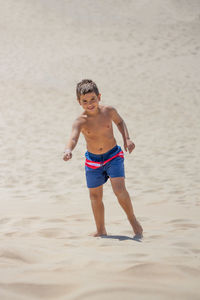 Funny kid dancing on a beach