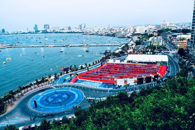High angle view of city by buildings against sky