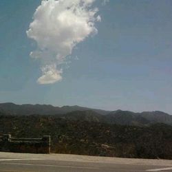 Scenic view of mountains against cloudy sky