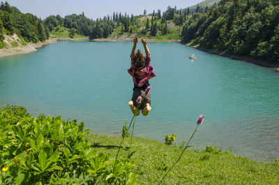 Woman with umbrella on riverbank