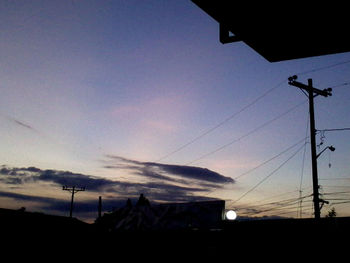 Low angle view of electricity pylon against sky