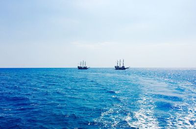 Ship sailing in sea against sky